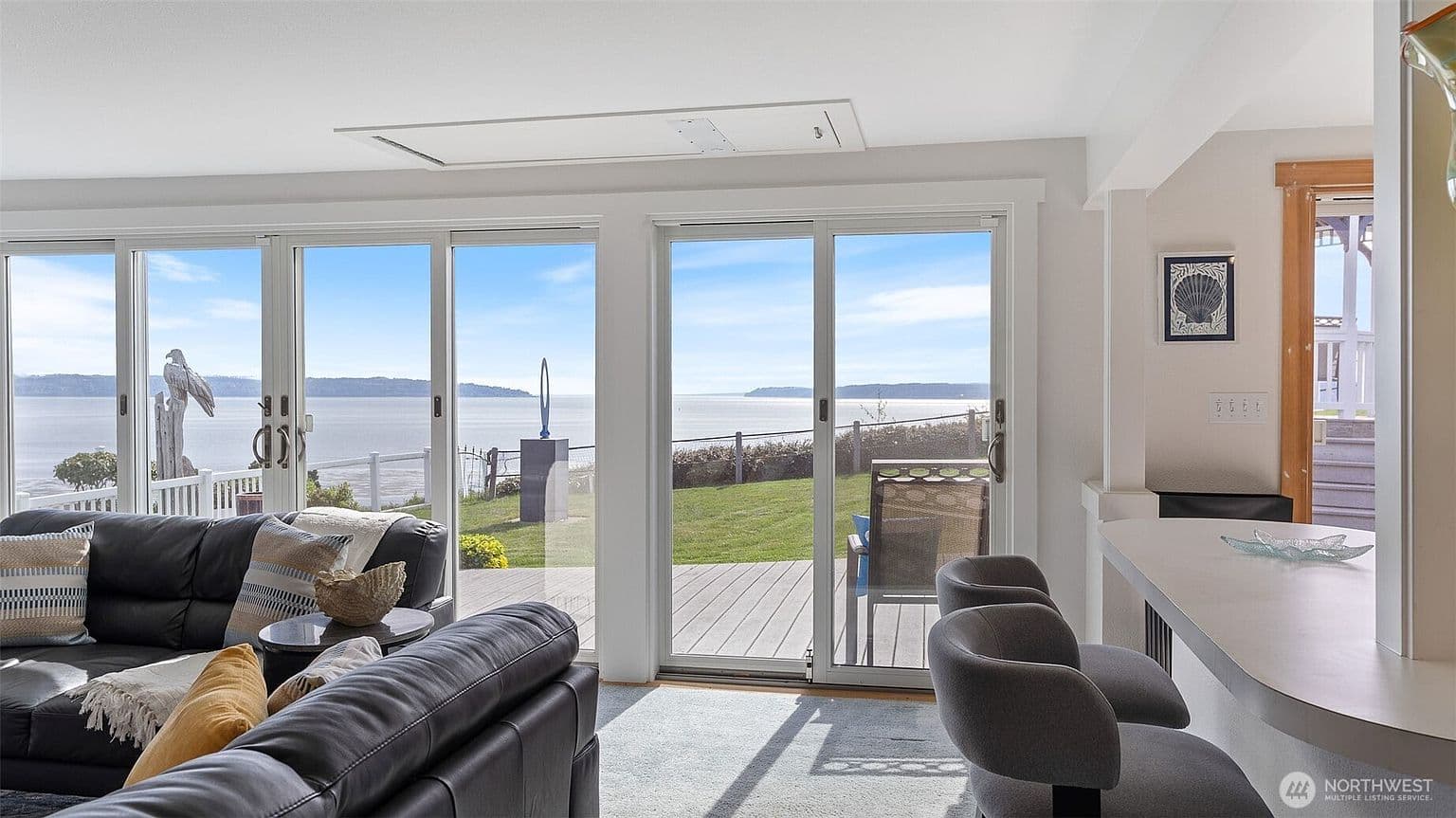 Floor-to-ceiling windows with Sound views from living room